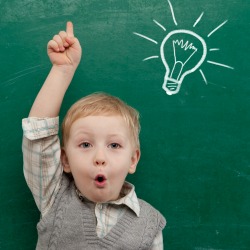 Cheerful smiling child at the blackboard. School concept