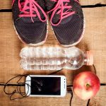 trainers, water bottle, phone and apple