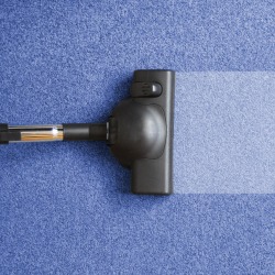vacuum cleaner on the floor showing house cleaning concept