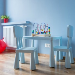 Blue baby room with small table and chairs, wooden flooring