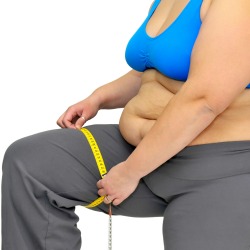 Large girl body part with measuring tape isolated in white