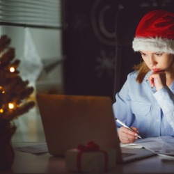 business woman businesswoman freelancer tired, asleep working at computer at Christmas