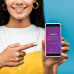 women pointing to instagram on her phone